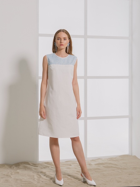 White dress with blue cross-stitching